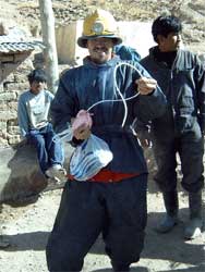 Coen holding a bar of burning dynamite in his hand